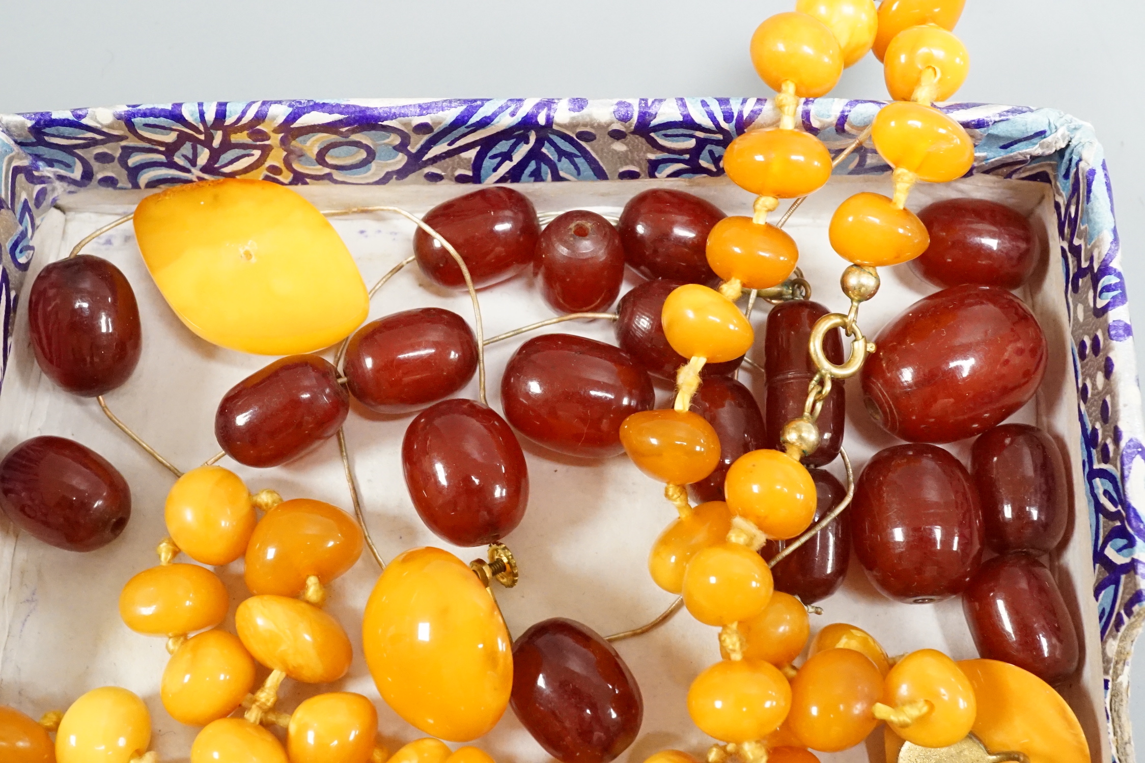 A single strand amber necklace, par of amber earrings and an amber pendant?(lacking fitting), gross weight 40 grams, together with a small quantity of loose simulated cherry amber beads.